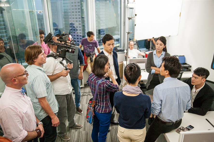 Hangzhou production team discussing a brief near a location setup